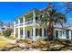Charming home exterior with a two-story porch, white columns, a palm tree, and well-maintained landscaping at 1003 Wichman St, Walterboro, SC 29488