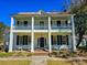 Charming two-story home with a spacious front porch, classic columns, and lovely dark shutters at 1003 Wichman St, Walterboro, SC 29488