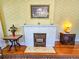 Detailed view of the living room fireplace with vintage decor and hardwood floors, highlighting the room's character at 1003 Wichman St, Walterboro, SC 29488