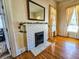 Fireplace with white brick and a hearth adjacent to windows dressed in elegant drapes at 1003 Wichman St, Walterboro, SC 29488