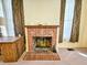 Close-up of a brick fireplace with decorative elements in a carpeted room with windows at 1003 Wichman St, Walterboro, SC 29488
