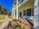 Inviting front porch with rocking chairs, brick steps, and charming columns on a two-story home at 1003 Wichman St, Walterboro, SC 29488