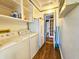 Functional laundry room with washer, dryer, and shelving for organized storage at 1003 Wichman St, Walterboro, SC 29488