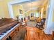 Open-concept living room with hardwood floors, a piano room, and a fireplace, creating an inviting space at 1003 Wichman St, Walterboro, SC 29488