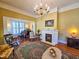 Elegant living room featuring hardwood floors, vintage decor, a fireplace, and a grand piano in an adjacent room at 1003 Wichman St, Walterboro, SC 29488