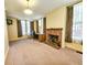 Bright living room featuring neutral walls, brick fireplace, desk and decorative curtains at 1003 Wichman St, Walterboro, SC 29488