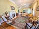 Elegant living room featuring hardwood floors, vintage furniture, a fireplace, and decorative wallpaper at 1003 Wichman St, Walterboro, SC 29488