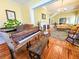 Open-concept living room with hardwood floors, a piano room, and a fireplace, creating an inviting space at 1003 Wichman St, Walterboro, SC 29488