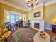 Elegant living room featuring hardwood floors, vintage decor, a fireplace, and a grand piano in an adjacent room at 1003 Wichman St, Walterboro, SC 29488