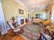 Elegant living room featuring hardwood floors, vintage furniture, a fireplace, and decorative wallpaper at 1003 Wichman St, Walterboro, SC 29488