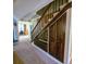 Carpeted staircase with dark wood banister and built-in storage cabinets at 1003 Wichman St, Walterboro, SC 29488