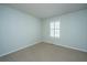 Neutral bedroom featuring carpeted floor and window with plantation shutters at 102 Challis Ct, Goose Creek, SC 29445