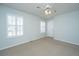 Bedroom featuring a ceiling fan, neutral carpet, and windows with shutters for ample light at 102 Challis Ct, Goose Creek, SC 29445