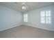 Well-lit bedroom with neutral carpet, a ceiling fan, and shuttered windows for natural light at 102 Challis Ct, Goose Creek, SC 29445