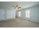 Large bedroom with carpeting, ceiling fan and natural light through windows with plantation shutters at 102 Challis Ct, Goose Creek, SC 29445