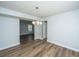 Open dining room featuring new floors, modern chandelier and adjoining space at 102 Challis Ct, Goose Creek, SC 29445