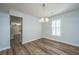 Open dining room featuring new floors, modern chandelier and shuttered window at 102 Challis Ct, Goose Creek, SC 29445