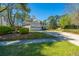View of the long driveway winding towards the home with the attached garage at 102 Challis Ct, Goose Creek, SC 29445