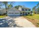 Home's well maintained lawn and landscaping leading up to the house and attached two car garage at 102 Challis Ct, Goose Creek, SC 29445