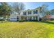 Charming home with a light gray exterior, red front door, and two-car garage at 102 Challis Ct, Goose Creek, SC 29445