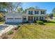 Home's landscaped front yard leads up to the house and attached two car garage at 102 Challis Ct, Goose Creek, SC 29445