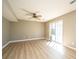 Bright living room featuring modern fan and sliding glass doors to the backyard at 102 Challis Ct, Goose Creek, SC 29445