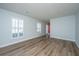 Open-concept living room featuring luxury vinyl plank flooring, fresh paint and a red front door at 102 Challis Ct, Goose Creek, SC 29445