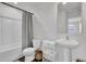 Clean bathroom with white fixtures, a shower/tub combo, and stylish storage shelving, offering a functional layout at 1032 Berry Patch Cir, Summerville, SC 29485