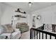 Bedroom view featuring dresser, chair, crib, and access to ensuite bathroom at 1032 Berry Patch Cir, Summerville, SC 29485