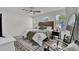 Bright bedroom with a large bed, a black nightstand, three windows, and an accent rug at 1032 Berry Patch Cir, Summerville, SC 29485