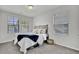 Bright bedroom with plush carpet, plenty of natural light from two windows, and a cozy bed with decorative pillows at 1032 Berry Patch Cir, Summerville, SC 29485