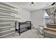 Charming Bedroom with wood accent wall, crib, cozy armchair, and soft lighting for a serene ambiance at 1032 Berry Patch Cir, Summerville, SC 29485