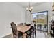 Dining room with a wooden table, chairs, hardwood floors, and a sliding glass door to the backyard at 1032 Berry Patch Cir, Summerville, SC 29485