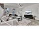 Comfortable living room with a modern TV, gray sofas, and large windows for plenty of natural light at 1032 Berry Patch Cir, Summerville, SC 29485