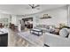 Open-concept living room featuring modern furniture, a ceiling fan, and hardwood flooring at 1032 Berry Patch Cir, Summerville, SC 29485