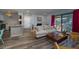 Bright living room boasts hardwood floors, a cozy fireplace, and access to a private balcony at 1054 Anna Knapp Blvd # 4E, Mount Pleasant, SC 29464