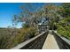 Wood walkway leading to a house surrounded by trees and marshland at 1054 Anna Knapp Blvd # 4E, Mount Pleasant, SC 29464