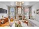 Well-lit living room with a brick fireplace, white sofa, wood floors and elegant decor at 106 Queen St # B, Charleston, SC 29401