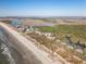 Scenic aerial view showcases the beachside homes and a path that leads to the shore at 1109 Diodia Ct, Kiawah Island, SC 29455