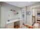 Bright home office featuring built-in desk, cabinets, natural light, and adjacent bathroom entry at 1109 Diodia Ct, Kiawah Island, SC 29455