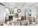 Bright kitchen with granite countertops, stainless steel appliances, white cabinets, and an adjacent breakfast bar at 1109 Diodia Ct, Kiawah Island, SC 29455