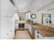 Updated kitchen features stainless appliances, custom cabinetry, granite countertops, and hardwood flooring at 1109 Diodia Ct, Kiawah Island, SC 29455