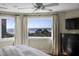Bright main bedroom with beach views from several windows, ceiling fan, and dark dresser at 1109 Diodia Ct, Kiawah Island, SC 29455