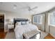 Serene main bedroom featuring a king bed, ceiling fan, walk-in closet, and ample natural light at 1109 Diodia Ct, Kiawah Island, SC 29455