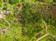 Overhead shot featuring a home surrounded by lush green trees within a vast woodland setting at 1117 Walleye Rd, Bonneau, SC 29431