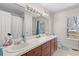 Bathroom featuring double sinks, large mirror, and natural light at 1117 Walleye Rd, Bonneau, SC 29431