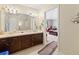 Bright bathroom with dual sinks, ample counter space, and wood cabinetry at 1117 Walleye Rd, Bonneau, SC 29431