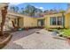 Open-air courtyard with concrete aggregate patio, lush landscaping and access to the home at 1117 Walleye Rd, Bonneau, SC 29431