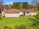 Rear exterior view of the home, highlighting the yard, paint, and a glimpse of the roof at 1117 Walleye Rd, Bonneau, SC 29431