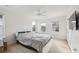 Bright bedroom featuring a ceiling fan, three windows, and a large bed at 120 Diploma Dr, Ladson, SC 29456